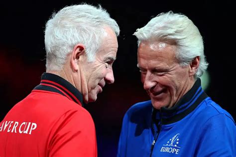 Roger Federer presents John McEnroe and Bjorn Borg with .